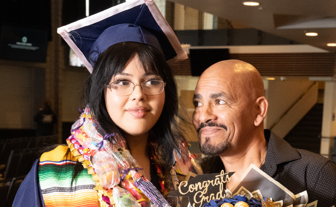 Graduating student with proud relative.