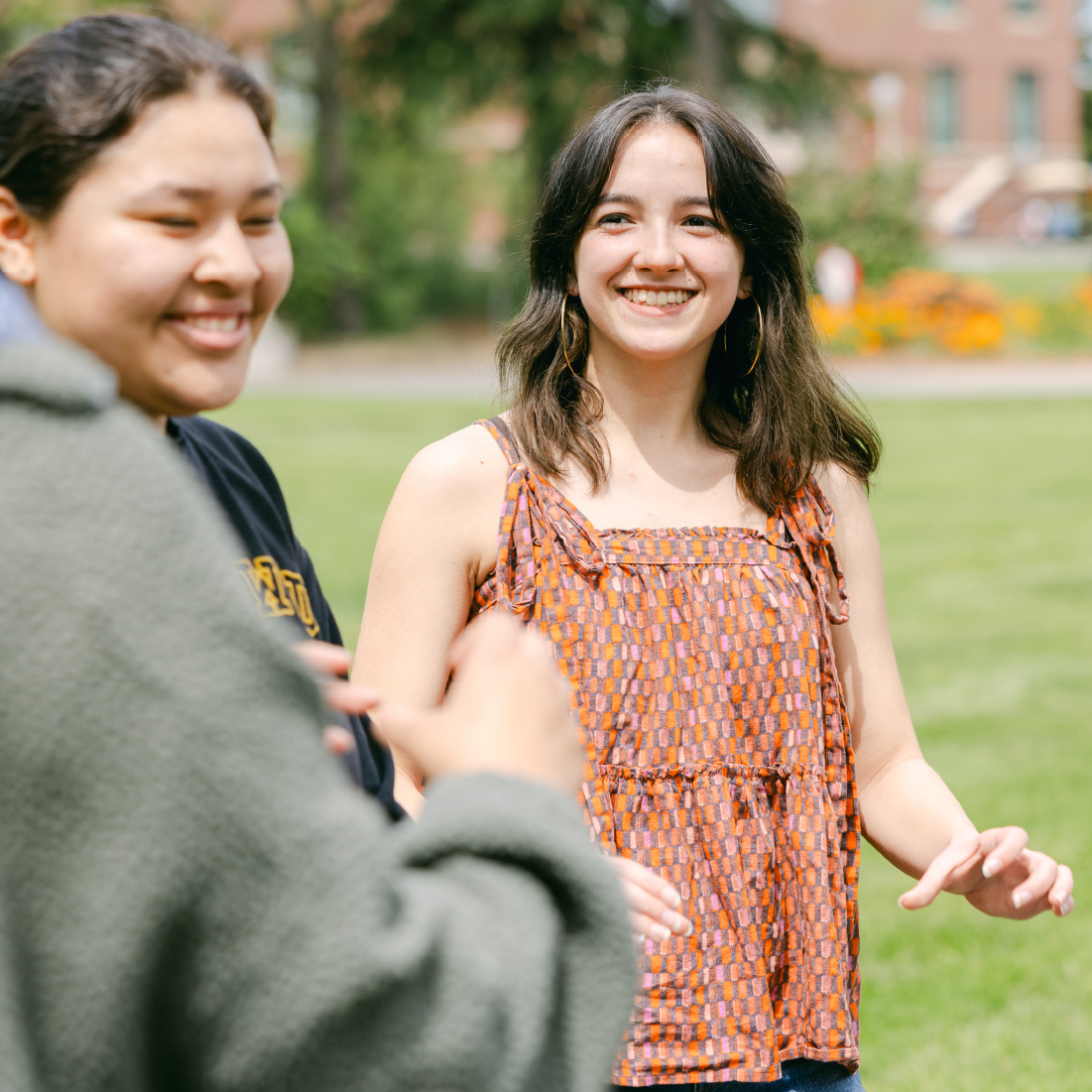 Two students laughing outdoors.