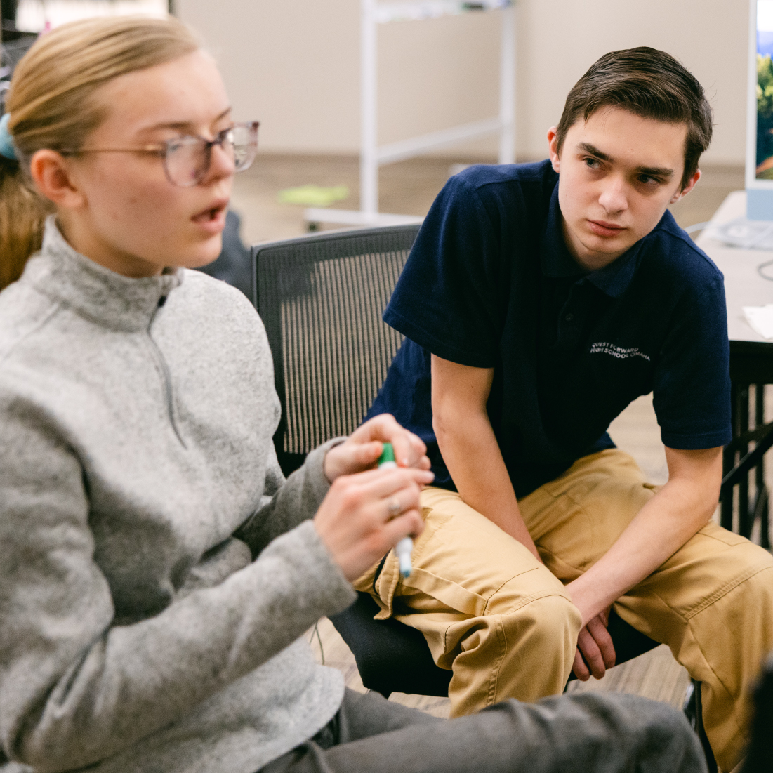 Student talking while another listens.