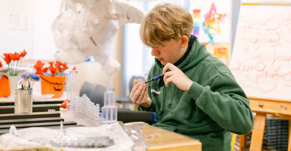 Student using a scientific tool.
