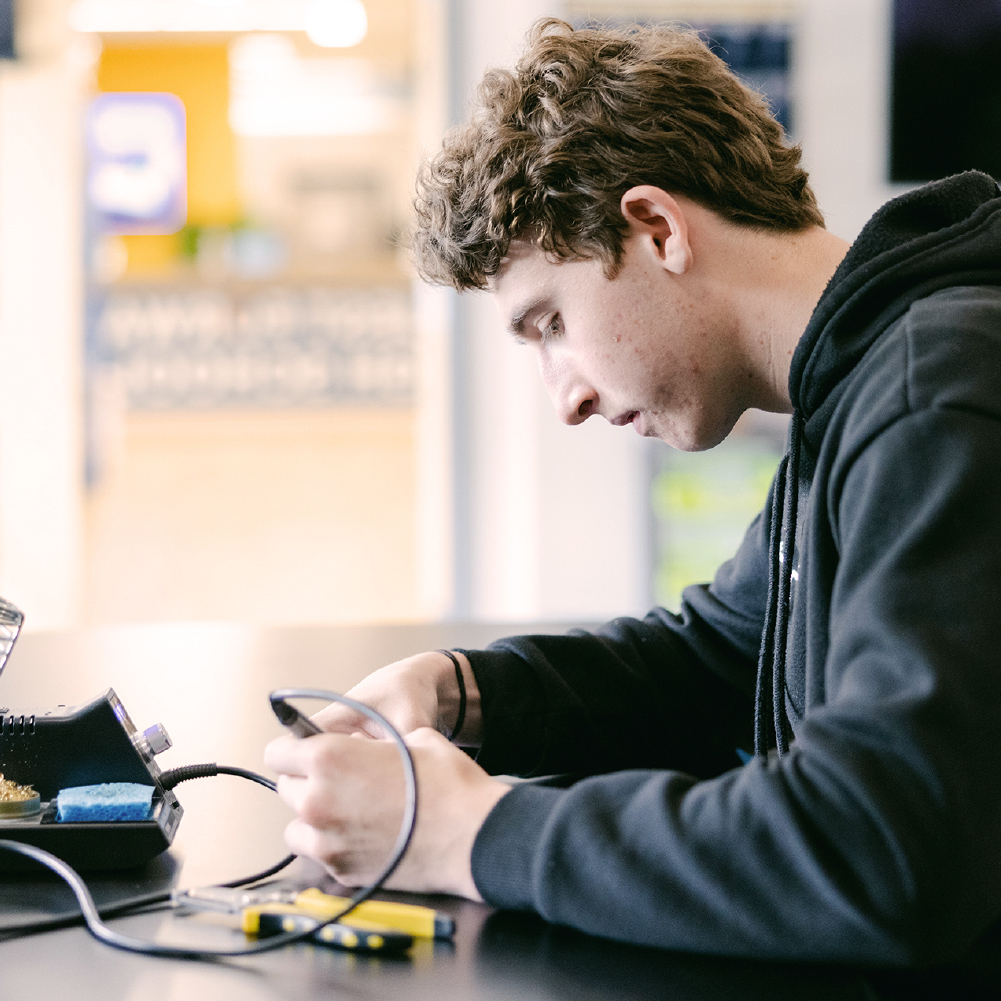 Student working with electrical tools.