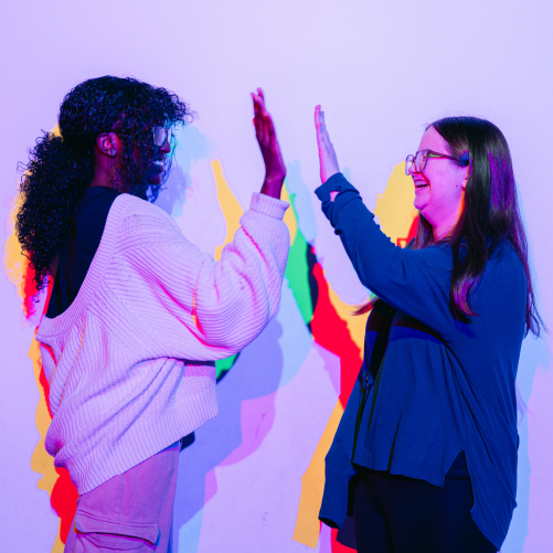 Two students giving each other a high five.