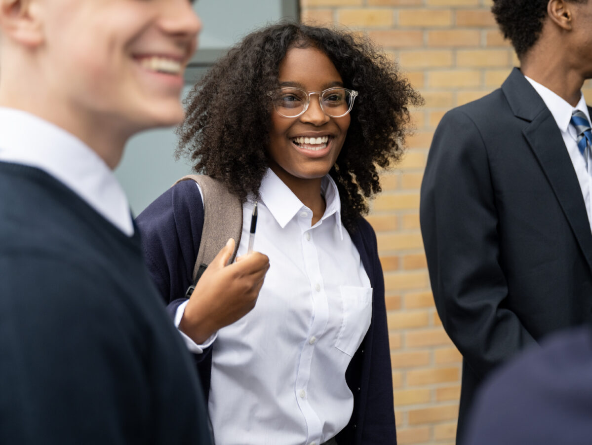 Student outside chatting with fellow students.
