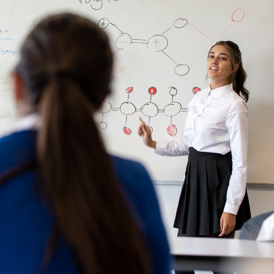 Female student leading science class.