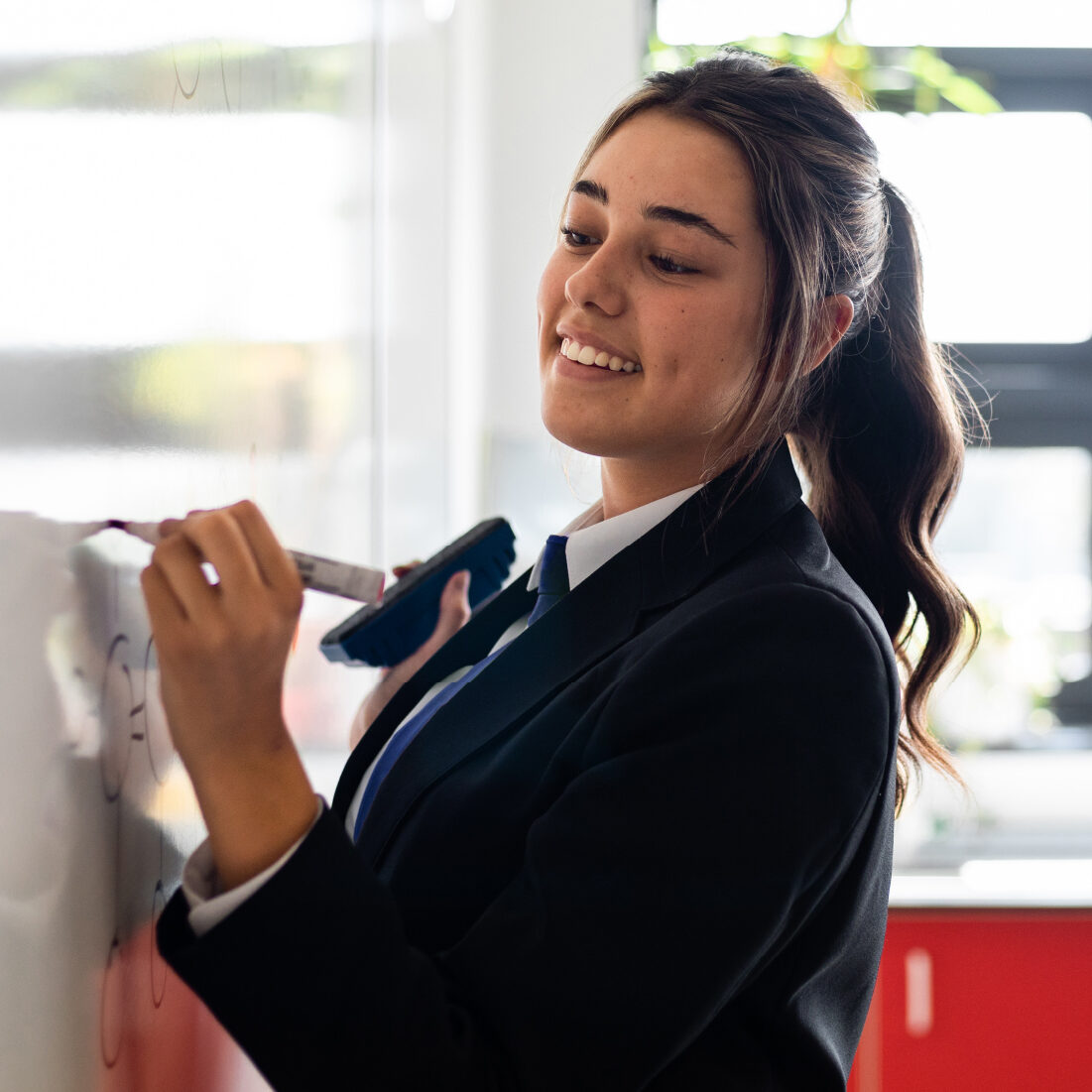 Student working at a white board.